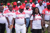 Asantehene Otumfuo Osei Tutu II flanked by golf fanatics at the Golf Open Championship