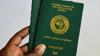 Person wey hold im copy of di Nigerian passport