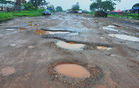 A photo of potholes on a road