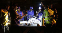 A group of polling agents sorting and collating election results