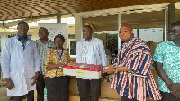 Ablakwa (in smock) hands over an equipment to a KBTH rep