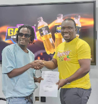 Fancy Gadam and a representative of Fenaam Gh ltd during the signing of the deal