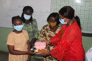 Mrs Akosua Frema Opare and Cynthia Morrison serving JHS candidates with Jollof rice