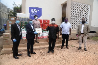 Nana Adu Keremateng, Head of Corporate Communications at Access Bank presents items to Albert Boakye