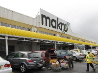 Shoppers load their goods into a car outside a Makro branch of South African retailer Massmart