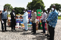 Mr Saeed (in white) receiving the items from Mr Gmabi