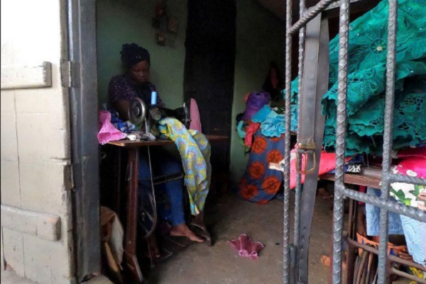 Kemi Adepoju, a dressmaker, sews a dress with a sewing machine in her shop amid the coronavirus