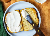 File photo of a slice of bread spread with mayonnaise