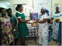 Mrs Rebecca Nkansah Kyeremateng (right) presenting the gifts to Mrs Elizabeth Ogoe Annan (left)