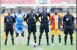 Lineup of match officials and skippers before game