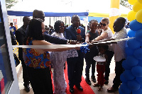 Mrs. Adelaide Siaw Agyepong, CEO of the school with others cutting the ribbon to inaugurate the sch.