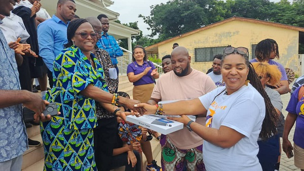 The headmistress receives the tablets on behalf of the school