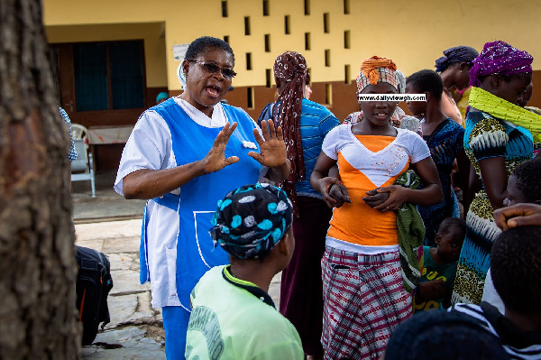 File photo: A healthcare personnel educating some teenagers