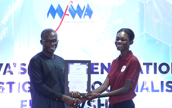 Executive Director of MFWA, Sulemana Braimah presenting a certificate to one of the fellows