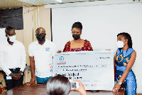 Sonotech presenting a dummy cheque to a surgeon at Korle-Bu Teaching Hospital