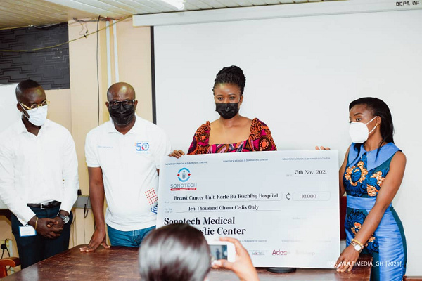 Sonotech presenting a dummy cheque to a surgeon at Korle-Bu Teaching Hospital