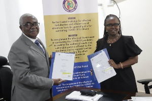 Prof. Dorothy Yeboah Manu, Director, NMIMR (right) with Dr William Collins Asare of COVID Fund