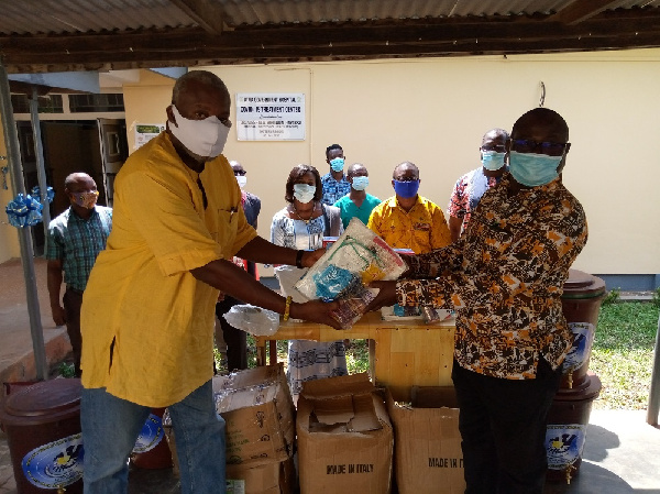 An official of Atua Government Hospital receiving the donation