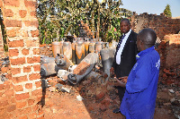 The mayor of Kawempe Division, Dr Emmanuel Serunjogi (left), inspecting gas cylinders