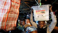 A Polling Agent carrying the ballot box