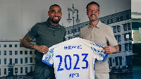 KP Boateng with an official of Hertha Berlin