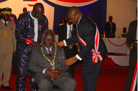 President George Manneh Weah decorating John Agyekum Kufuor