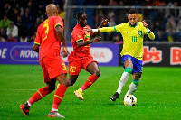 Neymar wards off a tackle by Kamaldeen Sulemana