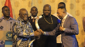 Rev. Owusu Bempah (r) presenting the horn to Akufo-Addo (l)