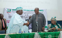 Former President John Dramani Mahama in a hand shake with Former President Obasanjo