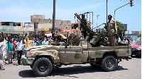 Sudanese greet army soldiers, loyal to army chief Abdel Fattah al-Burhan, in the Red Sea City