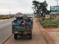 School kids using tricycle as means of transport