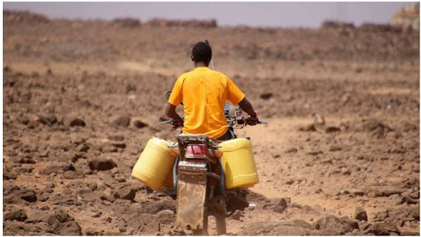 A man ferries water to his home in Kenya’s drought-hit Marsabit County