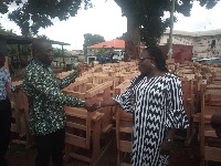 MCE for Lower Manya Krobo, Simon Tetteh presenting the furniture to Mrs Agnes Akweley Attipoe