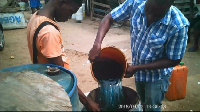 Fisherfolk transferring pre-mix fuel