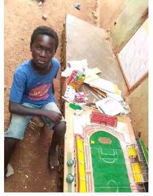 Desmond Amonuu by his architectural model of Axim Sports Complex