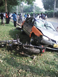 Taxi and motorbike lying on the ground as Police investigates incident