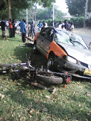 Taxi and motorbike lying on the ground as Police investigates incident