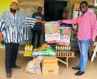 Charles Amoako Brobbey presenting some relief items