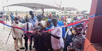 Nii Boye Laryea cutting the tap commission of the 42-market sheds