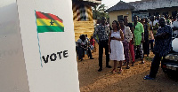 A photograph of people in queue to vote