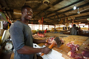 File Photo: A butcher cutting meat into pieces