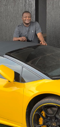 Hassan Ayariga poses with one of his cars