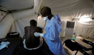 A Senegalese army doctor examines a local resident at the army field hospital