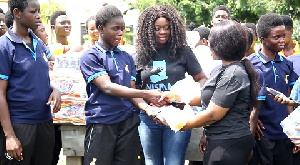 Nana Ama of Visma Foundation presenting the items to the Black Maidens