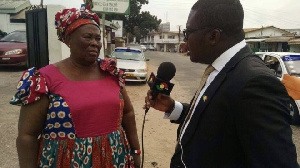 Hajia Fati speaking to a journalist in front of NPP headquarters