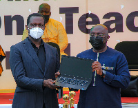 Dr Bawumia handing over a laptop to a teacher