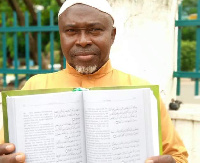 Sheikh Chukwuemeka with a copy of the Arabic - Igbo Quran