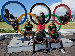 Ghana's athletics team pose with the Olympics logo at their base