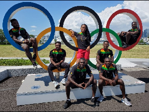 Ghana's athletics team pose with the Olympics logo at their base