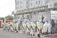 Some officials clad in PPEs engaged in the disinfection exercise at the Foreign Affairs Ministry